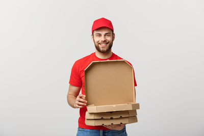 Portrait of smiling man standing against white background