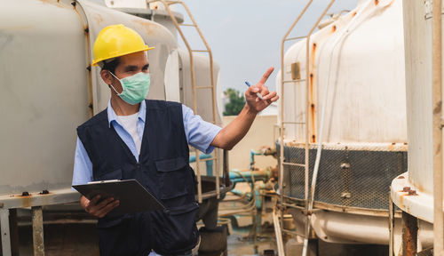 Young man working in factory