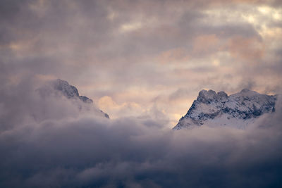 Low angle view of snow covered mountain against sky