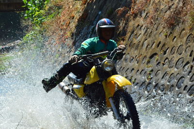 Man riding motorcycle on water