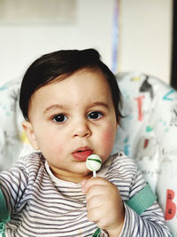 Close-up of cute girl eating food at home