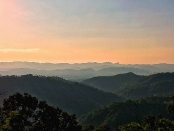 Scenic view of mountains against sky at sunset