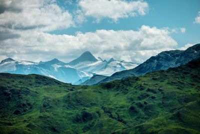 Scenic view of mountains against cloudy sky