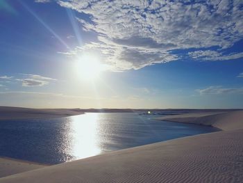 Scenic view of sea against bright sun