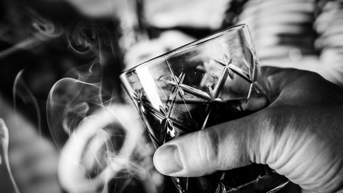 Close-up of hand holding drink glass