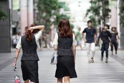 Rear view of women walking outdoors