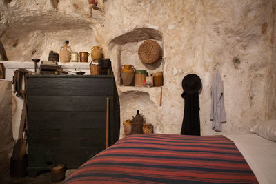 Cross on bed against wall at home