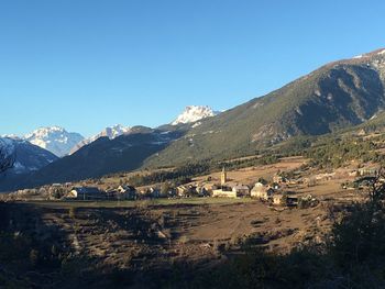 Scenic view of mountains against clear blue sky