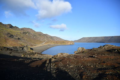 Scenic view of sea and mountains against sky