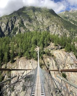 Suspension bridge in the mountains first person perspective 