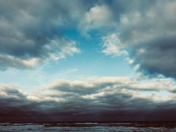 Scenic view of sea against dramatic sky