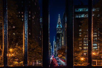 Illuminated modern building against sky at night