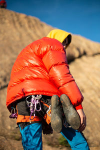 Rear view of man rock climbing