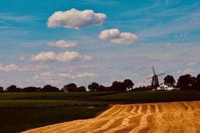 Scenic view of agricultural field against sky