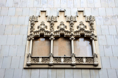 Low angle view of statue against building