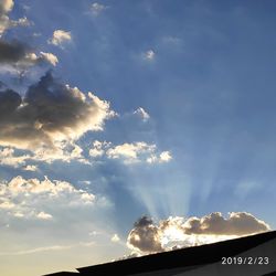 Low angle view of text against sky during sunset