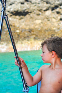 Portrait of shirtless boy in swimming pool