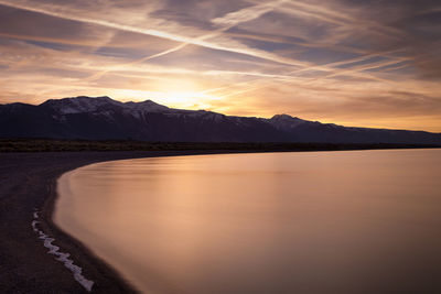 Scenic view of mono lake and mountains against sky during sunset