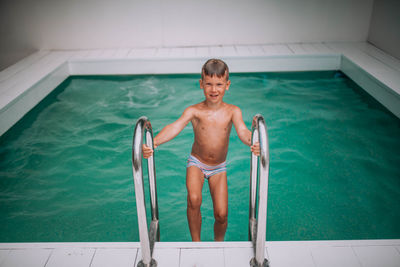 Portrait of happy boy in swimming pool