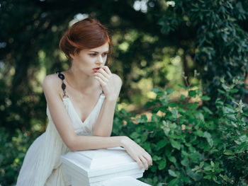 Young woman sitting outdoors