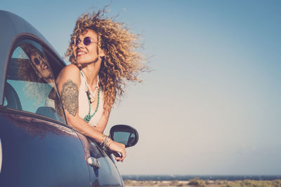 Woman wearing sunglasses against sky