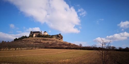 Castle on field against sky