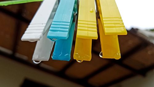 Close-up of clothespins hanging on clothesline