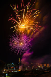 Low angle view of firework display at night