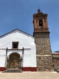 Low angle view of clock tower against sky