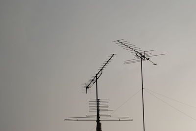 Low angle view of communications tower against clear sky