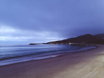 Scenic view of beach against sky during sunset