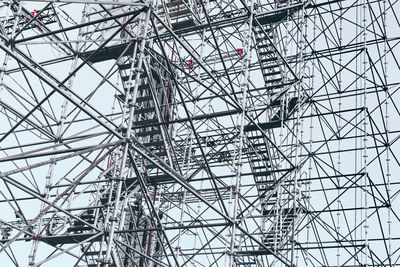 Low angle view of ferris wheel against sky