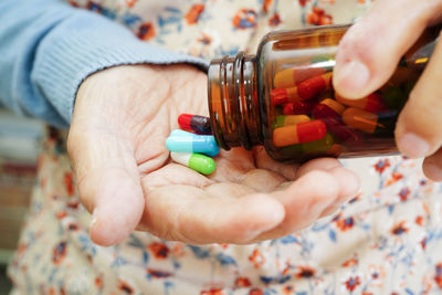 Cropped hand holding pills