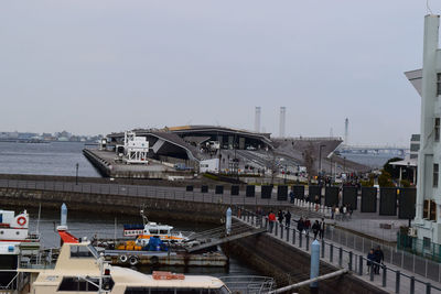 Boats in river with city in background