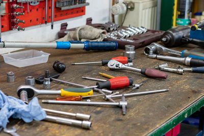Close-up of work tools on workbench at workshop