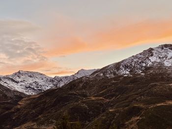 Scenic view of snowcapped mountains against sky during sunset