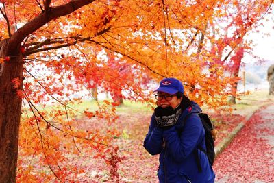 Woman standing in park during autumn