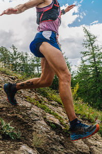 Low section of woman jumping on field