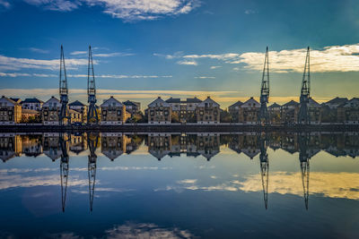 Reflection of buildings in lake against sky