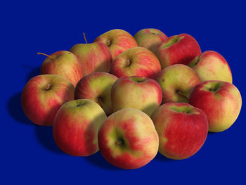 Close-up of fruits against blue background