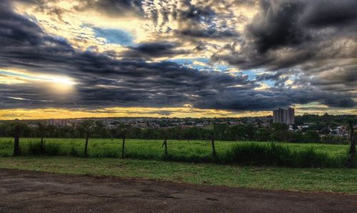 Scenic view of dramatic sky over field