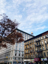 Low angle view of building against cloudy sky