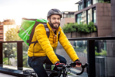 Portrait of smiling man with bicycle