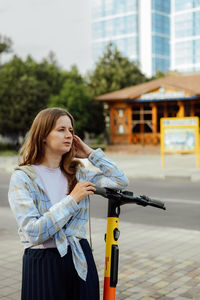 Portrait of smiling young woman standing on street