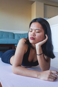 Young woman resting on mat yoga after practicing yoga