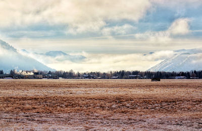 Scenic view of field against sky during winter