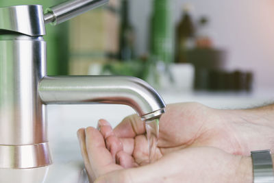 Close-up of human hand holding metal