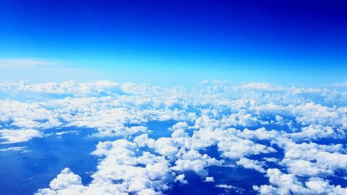 Aerial view of majestic mountains against blue sky