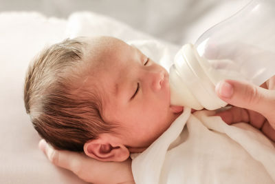 Cute baby girl lying on bed