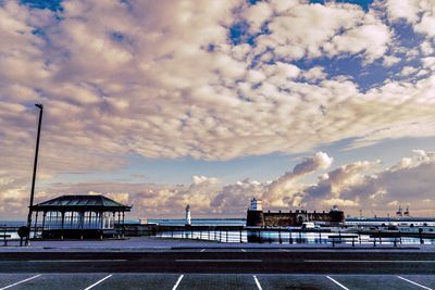 Harbor against cloudy sky